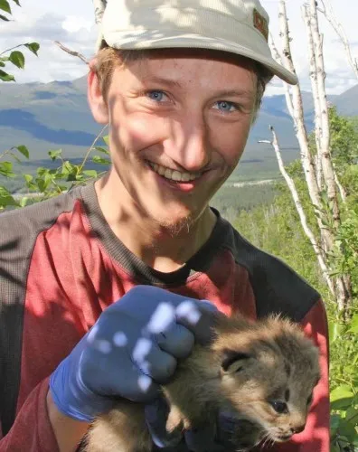 man holding a small animal